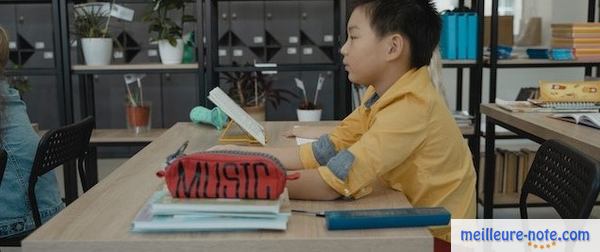 un garçon sur le banc d'école